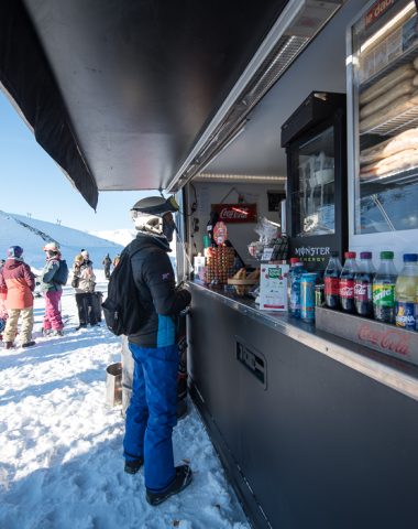 skiers next to a snack bar in valmeinier